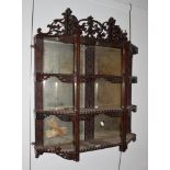 A mirrored mahogany display shelf