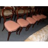 A set of six Victorian walnut balloon back salon chairs