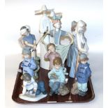 A collection of eleven Nao figures, together with a single Lladro figure of two nuns, and a small