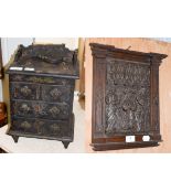 A 19th century papier mache miniature chest of drawers and a 17th century carved oak panel (2)