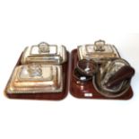 A pair of silver plated entree dishes, covers and handles, each with gadrooned borders, together