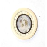 A 19th century portrait miniature in ivory and bronze frame, possibly French