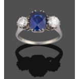 A Synthetic Sapphire and Diamond Three Stone Ring, the fancy cushion cut sapphire flanked by two old
