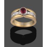 An 18 Carat Two Colour Gold Ruby and Diamond Ring, the oval cut ruby in a white rubbed over setting,