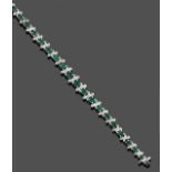 An Emerald and Diamond Bracelet, graduated round cut emeralds alternate with four round brilliant