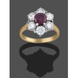 An 18 Carat Gold Ruby and Diamond Cluster Ring, the round cut ruby within a border of round