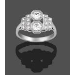 An Art Deco Style Diamond Ring, two round brilliant cut diamonds set perpendicular to the shank,