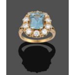 An Aquamarine and Diamond Cluster Ring, the cushion cut aquamarine within a border of round