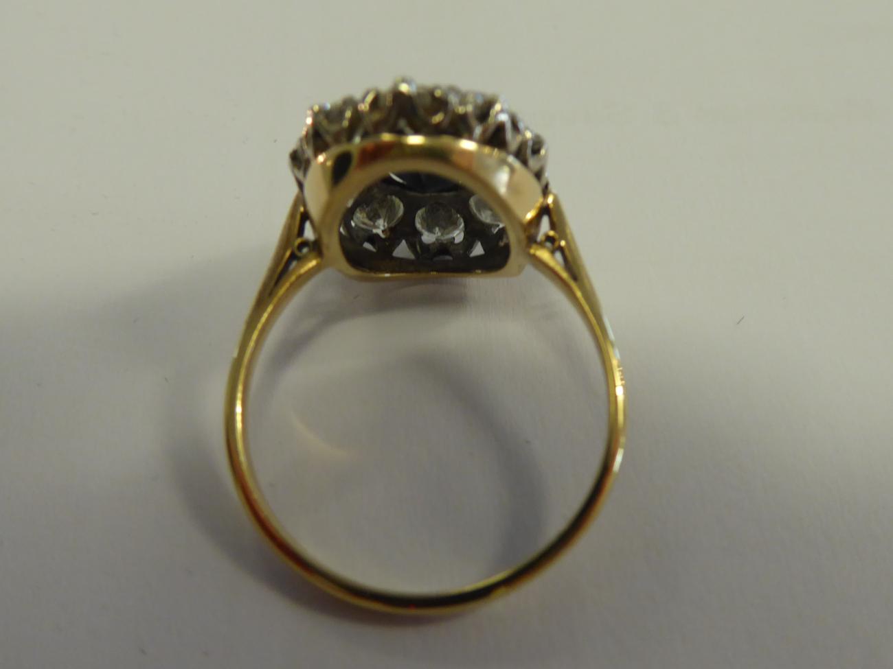 A Sapphire and Diamond Cluster Ring, the oval cut sapphire within a border of round brilliant cut - Image 2 of 5