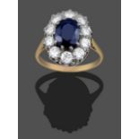 A Sapphire and Diamond Cluster Ring, the oval cut sapphire within a border of round brilliant cut