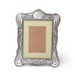 An Edward VII Silver Photograph-Frame, Maker's Mark Indistinct, Chester, 1908, shaped oblong, the