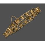 A Fancy Link Bracelet, formed of sixteen yellow floral motif links, length 19.5cm see illustration .