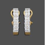 A Pair of Diamond Earrings, seven pairs of round brilliant cut diamonds spaced by fixed white