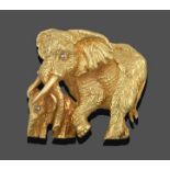 An Elephant and Calf Brooch, realistically modelled in a walking pose, with diamond set eyes in