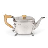 A George VI Silver Teapot, by Stower and Wragg Ltd., Sheffield, 1938, oblong and on four scroll