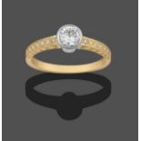 An 18 Carat Gold Diamond Solitaire Ring, a round brilliant cut diamond in a white rubbed over
