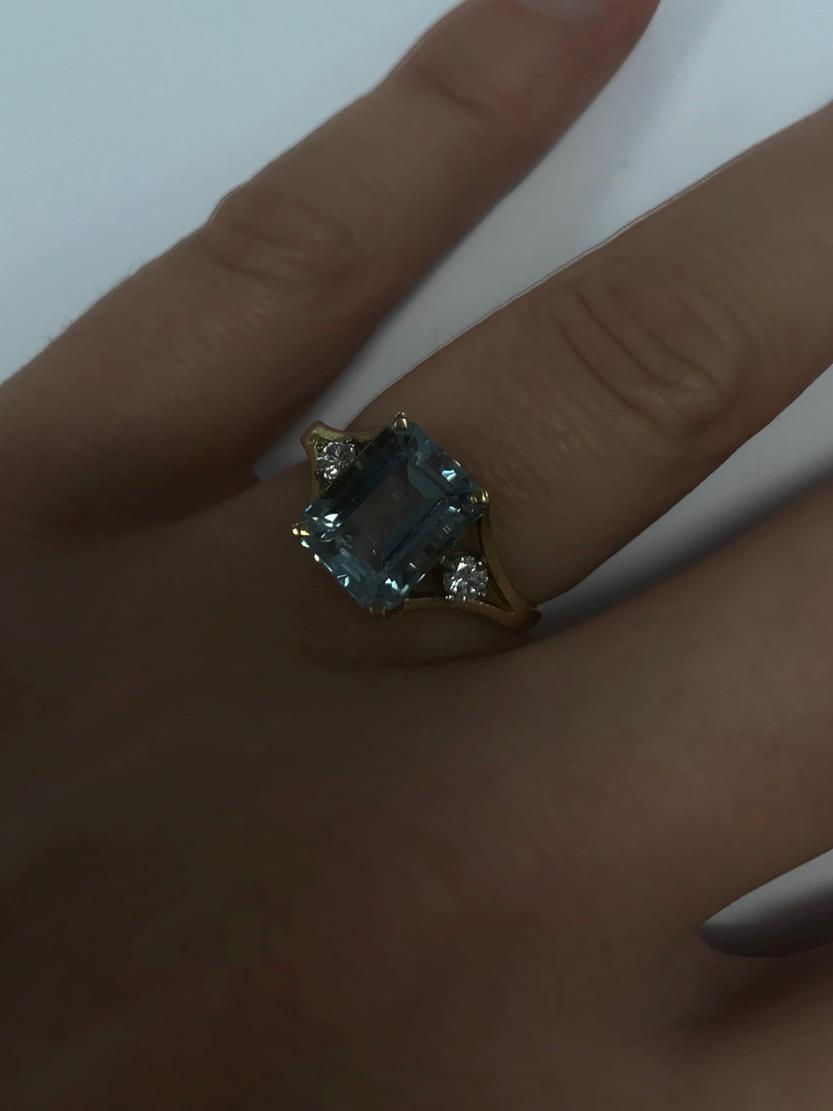 An 18 Carat Gold Aquamarine and Diamond Ring, the emerald-cut aquamarine in a yellow claw setting, - Image 7 of 7