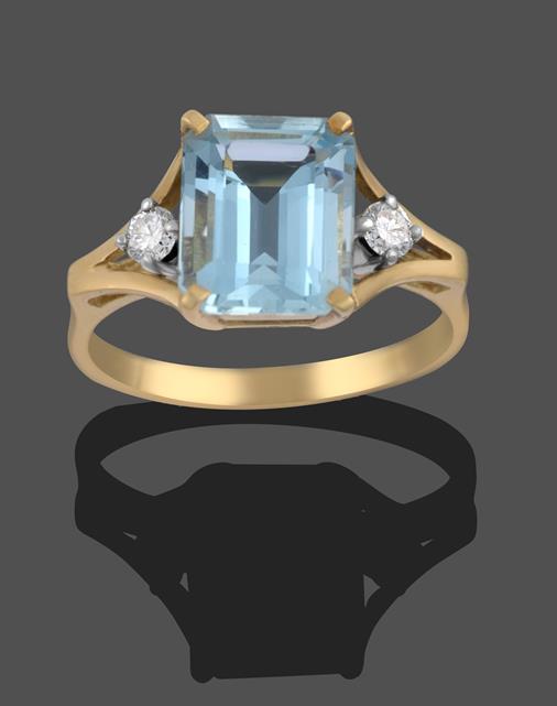 An 18 Carat Gold Aquamarine and Diamond Ring, the emerald-cut aquamarine in a yellow claw setting,