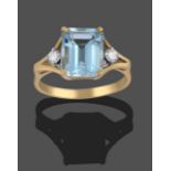 An 18 Carat Gold Aquamarine and Diamond Ring, the emerald-cut aquamarine in a yellow claw setting,