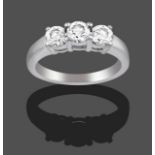 An 18 Carat White Gold Diamond Three Stone Ring, the round brilliant cut diamonds in claw