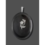 A Jet and Diamond Pendant, the oval polished jet plaque with a rose cut and eight-cut diamond floral