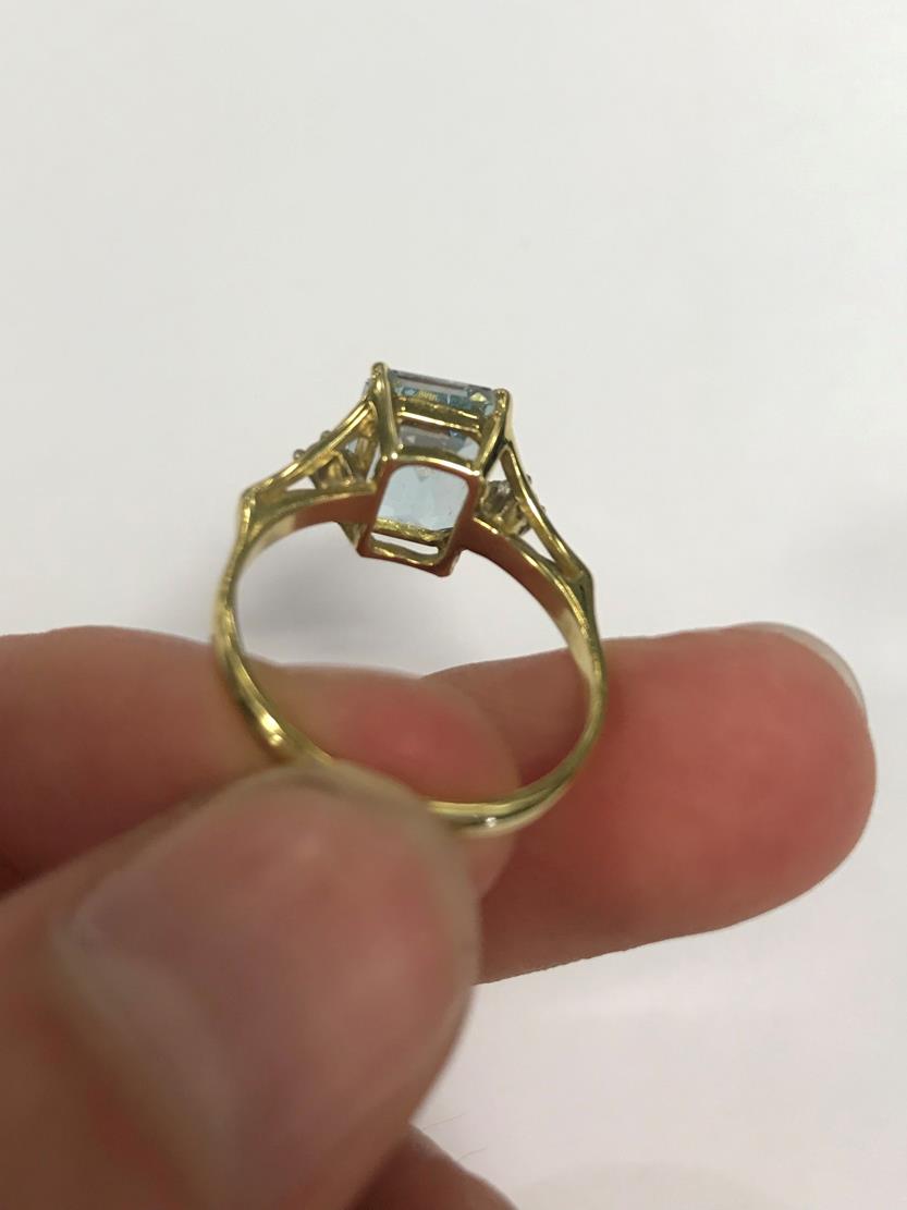 An 18 Carat Gold Aquamarine and Diamond Ring, the emerald-cut aquamarine in a yellow claw setting, - Image 4 of 7