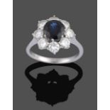 A Sapphire and Diamond Cluster Ring, the central round cut sapphire within a border of round