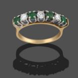 An 18 Carat Gold Emerald and Diamond Seven Stone Ring, four round cut emeralds alternate with