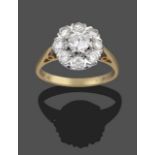 An 18 Carat Gold Diamond Cluster Ring, the central round brilliant cut diamond within a border of