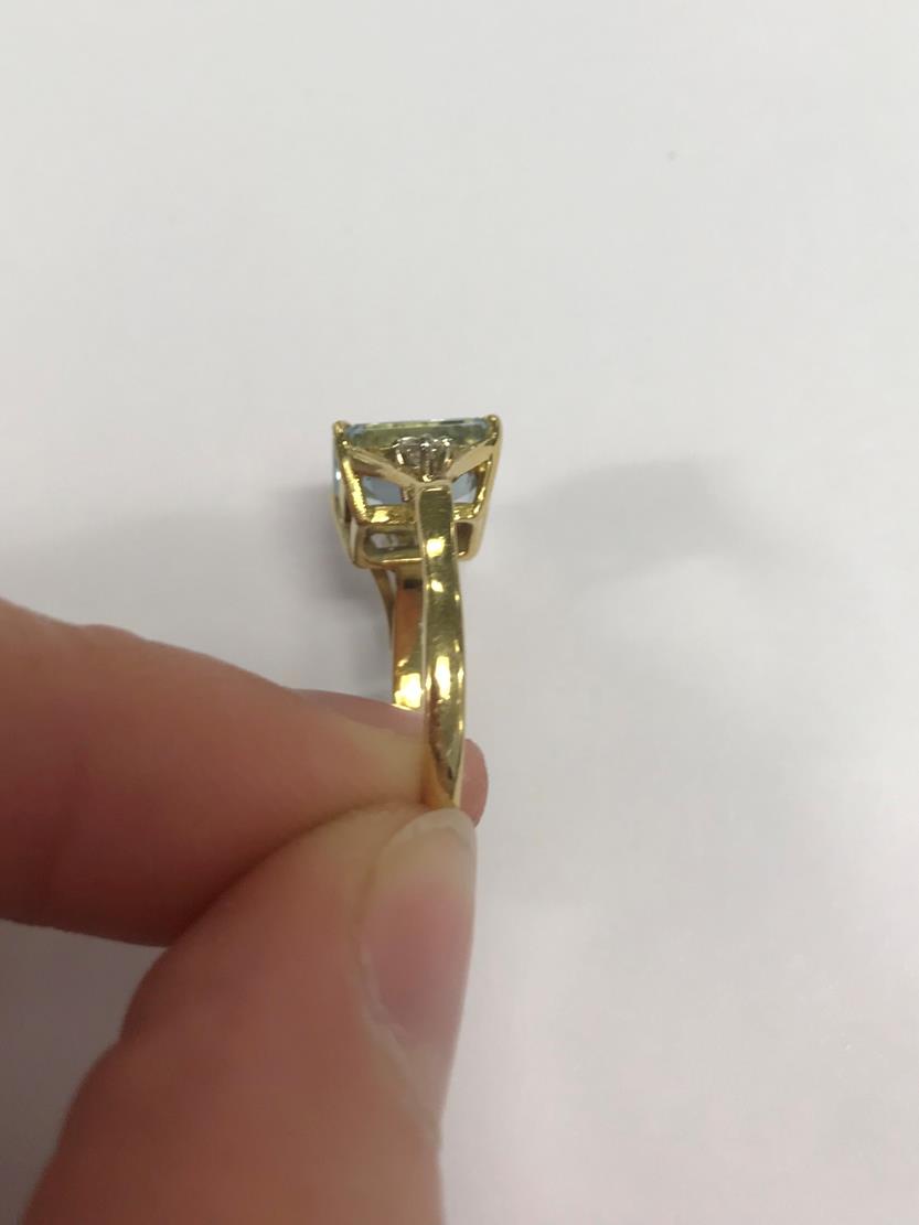 An 18 Carat Gold Aquamarine and Diamond Ring, the emerald-cut aquamarine in a yellow claw setting, - Image 3 of 7