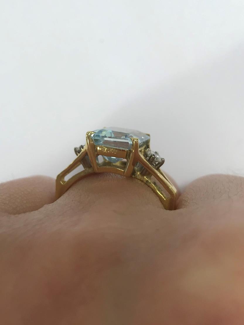 An 18 Carat Gold Aquamarine and Diamond Ring, the emerald-cut aquamarine in a yellow claw setting, - Image 6 of 7