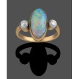 An Opal and Diamond Three Stone Ring, the oval cabochon opal in a yellow millegrain setting