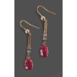 A Pair of Synthetic Ruby and Diamond Drop Earrings, a yellow bead suspends a tapered