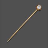 A Diamond Stick Pin, an old cut diamond in a yellow claw setting to a scroll border, estimated