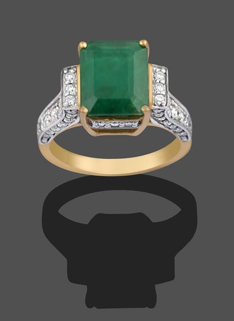 A 9 Carat Gold Emerald and Diamond Ring, the emerald-cut emerald in a yellow four claw setting, to