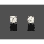 A Pair of Diamond Solitaire Earrings, the round brilliant cut diamonds in white four claw