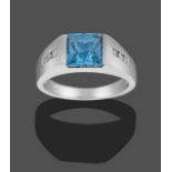 An 18 Carat White Gold Blue Topaz and Diamond Ring, the scissor cut blue topaz in a white rubbed