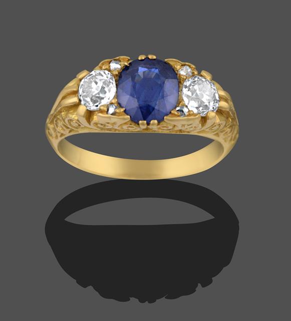 A Sapphire and Diamond Three Stone Ring, an oval cut sapphire sits between two old cut diamonds,