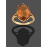 A Citrine Ring, the oval cut citrine in a yellow double claw setting, to a trifurcated shoulder