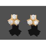 A Pair of 18 Carat Gold Diamond Cluster Earrings, trios of round brilliant cut diamonds spaced by