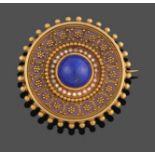 A Victorian Lapis Lazuli and Enamel Brooch, of circular form, the central round cabochon lapis
