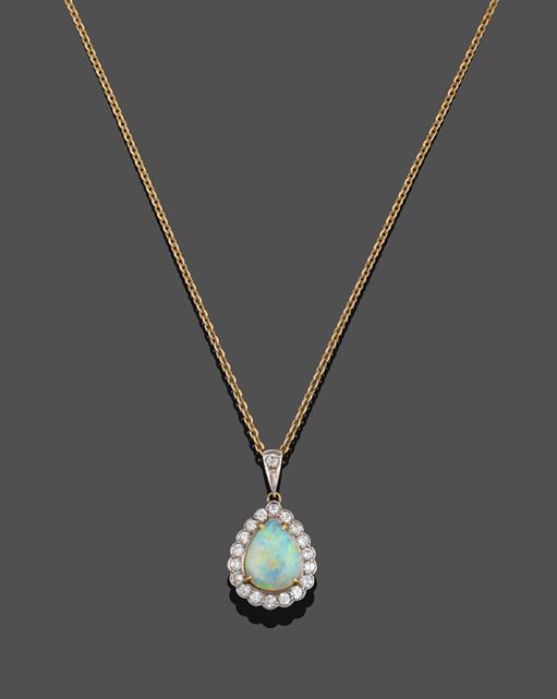 An 18 Carat Gold Opal and Diamond Cluster Pendant on Chain, the pear cut cabochon opal in a yellow