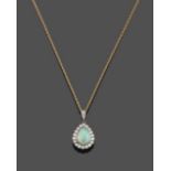 An 18 Carat Gold Opal and Diamond Cluster Pendant on Chain, the pear cut cabochon opal in a yellow