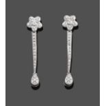 A Pair of Diamond Drop Earrings, a floral motif suspends three articulated links to a pear drop, set