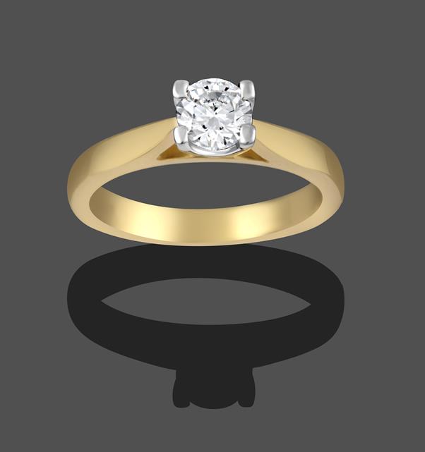 An 18 Carat Gold Diamond Solitaire Ring, a round brilliant cut diamond in a yellow claw setting,
