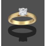 An 18 Carat Gold Diamond Solitaire Ring, a round brilliant cut diamond in a yellow claw setting,