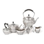 A Four-Piece Edward VII Silver Tea-Service with a Victorian Silver Tea-Caddy En-Suite, by William