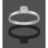 A Platinum Diamond Solitaire Ring, the round brilliant cut diamond in a claw setting, to a tapered
