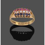 An 18 Carat Gold Ruby, Sapphire and Diamond Ring, rows of round cut rubies, rose cut diamonds and