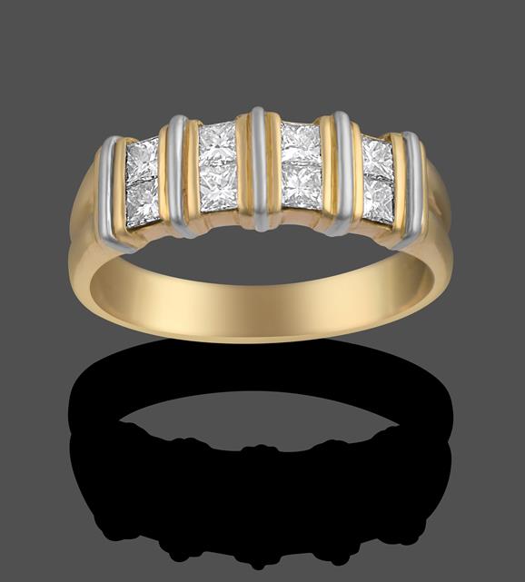 An 18 Carat Gold Diamond Ring, four pairs of princess cut diamonds spaced by fixed yellow bars, to a